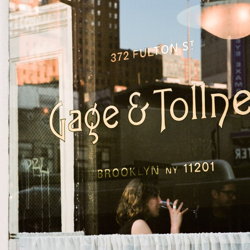 Gilded lettering on a window, "Gage & Tollner"