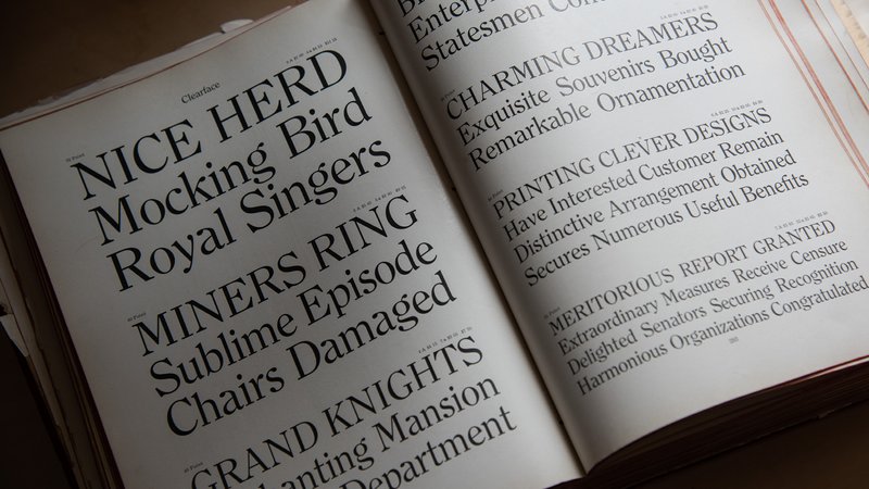 The 1912 American Type Founders catalog rests open to a spread showing the typeface Clearface