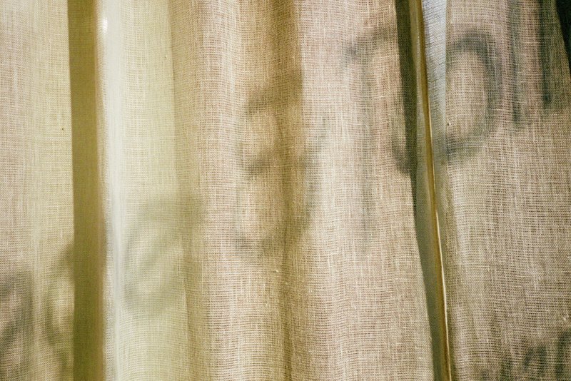 Shadow of the Gage & Tollner logo on a curtain