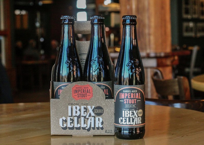 A styled photo of a six-pack of beer with "From the Ibex Cellar" logo on cardboard case
